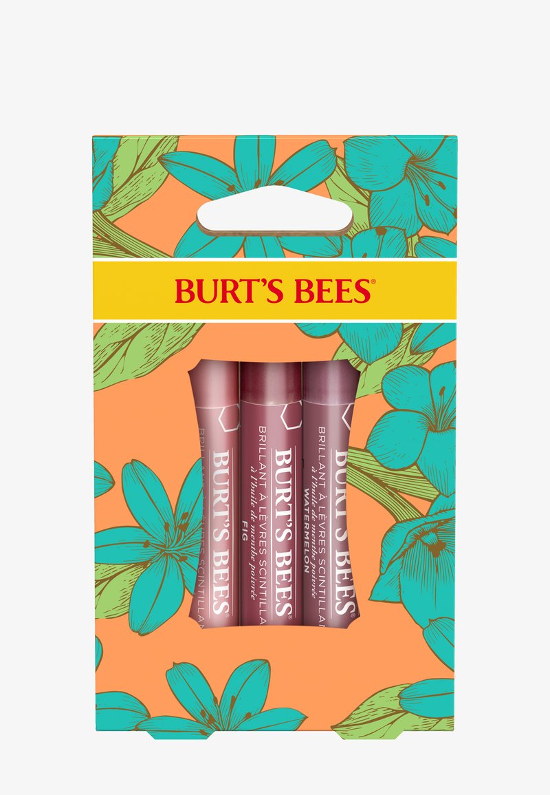 Kolme Burt's Bees -sävyttävää huulivoideputkea eri sävyissä, esillä kukkakuvioisessa oranssi-turkoosissa pakkauksessa, jossa on keltainen Burt's Bees -etiketti.