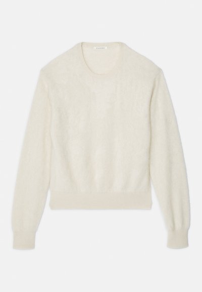 Krämfärgad långärmad fluffig tröja med ribbade mudd och nederdel, rund halsringning och diskret logobroderi på vänster ärm.