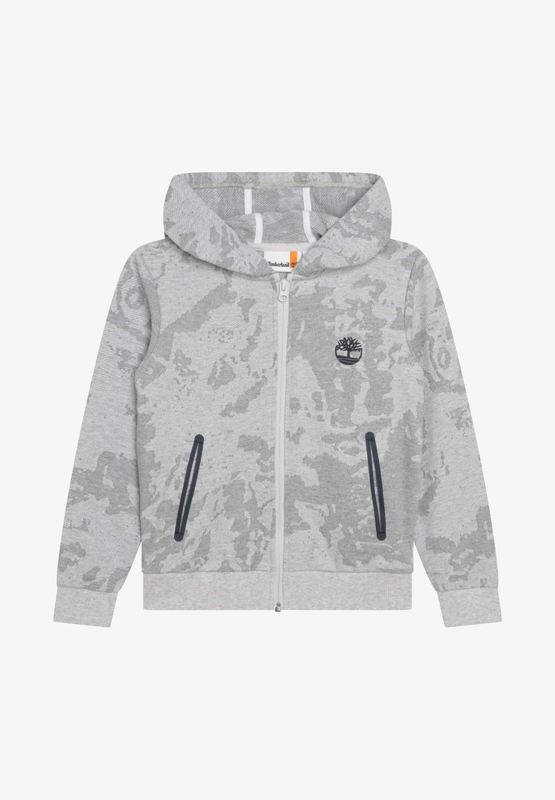 Grå zip-up hoodie med camouflage-mönster, kängurufickor och en liten logotyp. Har en foderhuva och ribbade ärmslut.