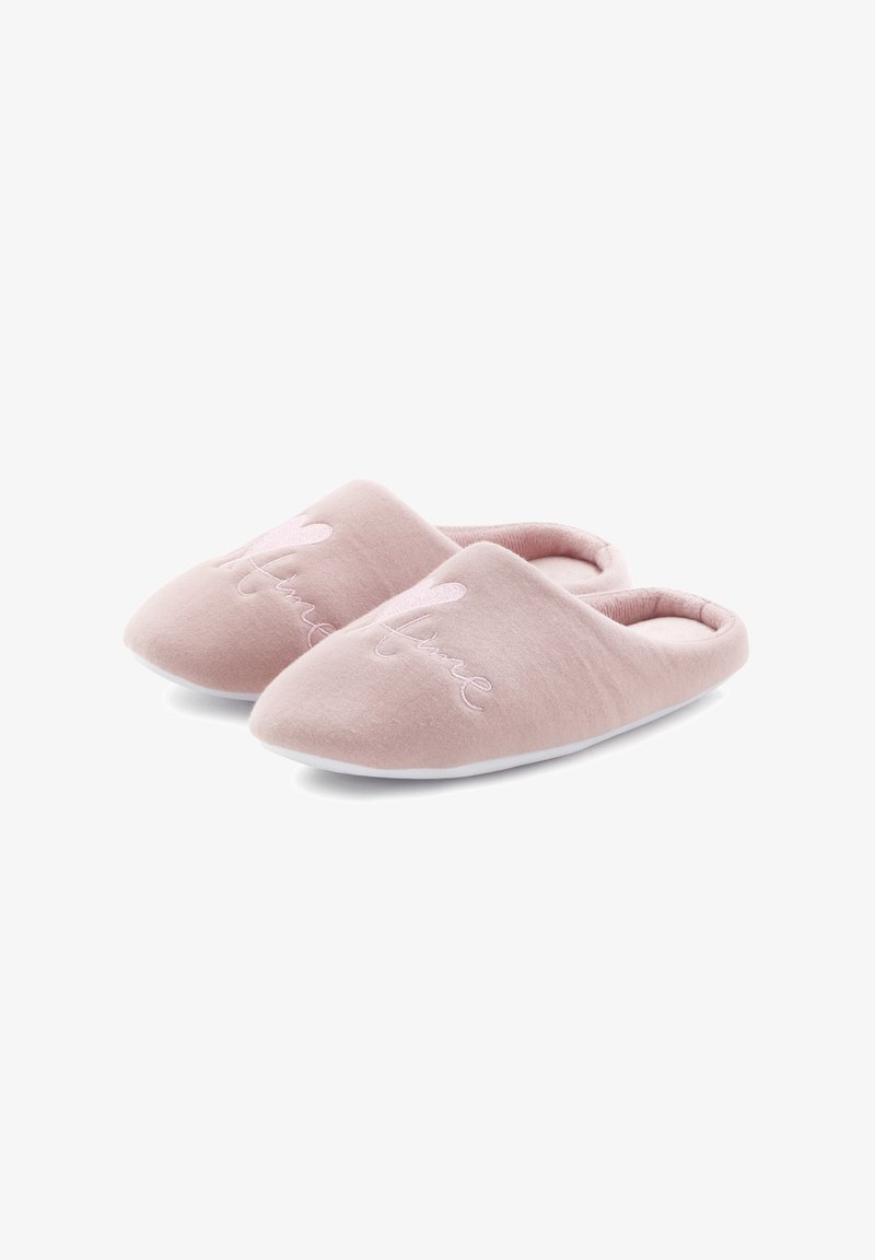 Pink fabric slippers with a soft texture, open back design, and embroidered "Home" detail on the upper. White soles.