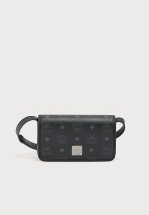 Sac bandoulière en cuir noir avec motif logo MCM embossé, forme rectangulaire, ferrures argentées et bandoulière réglable.