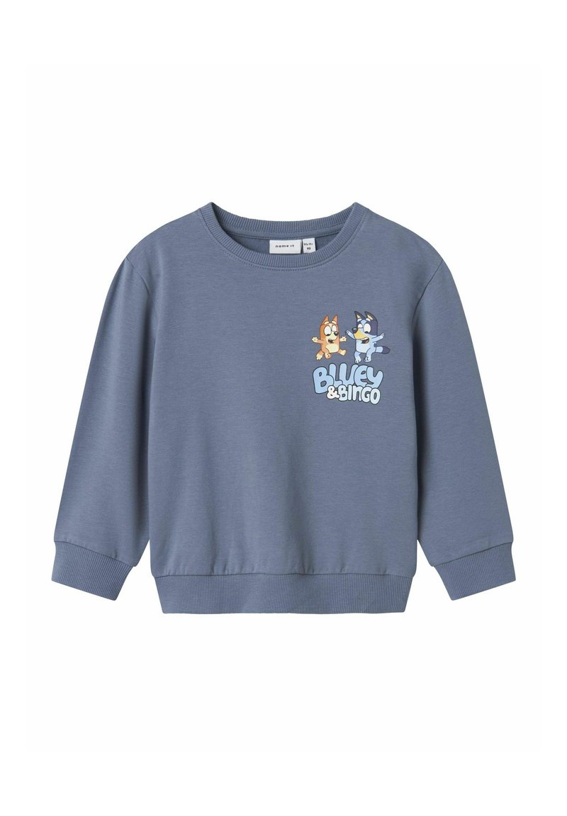 Sinine dressipluus pehmest kangast, ümmarguse kaelusega ja pikkade varrukatega. Esipaneelil on kahe koomiksitegelase trükitud kujundus.