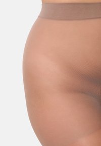 Durchsichtige Strumpfhosen in einem hellen Beige mit glatter Textur. Mit einem breiten, elastischen Bund und nahtlosem Design.