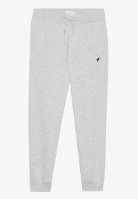Gray sweatpants made from soft fabric, featuring an elastic waistband with drawstring, side pockets, and a small black logo on the left thigh.