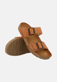Brown leather sandals with two adjustable buckles, cork footbed, textured rubber sole, and open-toe design.