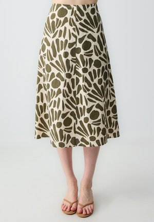 Gonna a trapezio realizzata in tessuto beige, caratterizzata da un audace motivo astratto verde. Lunghezza fino al polpaccio con taglio dritto e orlo svasato.