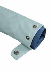 Light blue waterproof jacket sleeve with navy fabric lining, featuring snap buttons and a smooth texture.