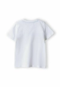 T-shirt en coton blanc à manches courtes, col rond et texture lisse. Design simple sans motifs ni embellissements.