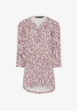 Túnica de manga larga en color burdeos con un patrón floral blanco. Presenta un escote redondo, detalle de botones y un dobladillo curvado para un ajuste relajado.