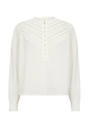 Blusa bianca a maniche lunghe con colletto arricciato, dettagli in pizzo decorativo e una fila di bottoni sul davanti. Polsini arricciati.