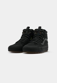 Black high-top sneakers with textured suede and durable fabric, featuring lace-up closure, reinforced toe, and gum rubber outsole.