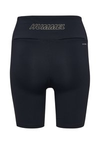 Svarta Hummel sportshorts med hög midja, med "HUMMEL"-logotyp tryckt i guld. Slät textur med en åtsittande design.