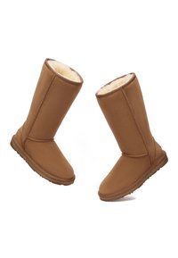 Braune Stiefel bis zur Mitte der Wade mit einer weichen, strukturierten Außenseite und luxuriösem Innenfutter. Runde Zehenform, flache Sohle und gestickte Akzente.