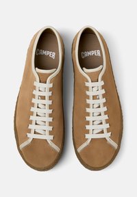 Light brown suede sneakers with cream laces and rubber soles, branded "CAMPER" on the insoles, viewed from above.