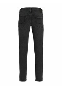 Jeans negri din denim cu un croi slim, având o textură netedă, două buzunare la spate și un logo subtil pe talie.