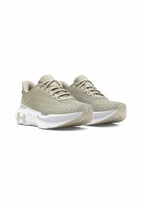 Beige athletic shoes with a textured mesh upper, cushioned sole, and white accents. Features a lace-up design and reinforced heel.