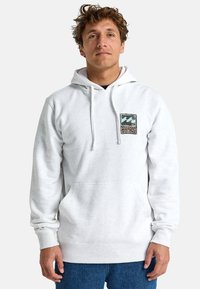 Gray hoodie with a front kangaroo pocket, drawstring hood, and graphic detailing on the chest. Soft fabric with ribbed cuffs.