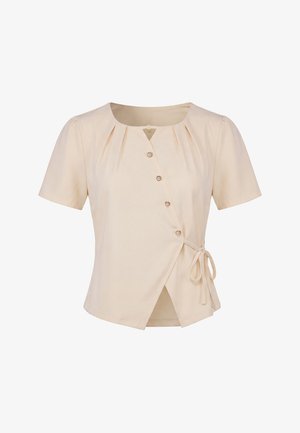 Beigefarbene Bluse mit kurzen Ärmeln, rundem Ausschnitt, asymmetrischen Knöpfen vorne, Falten am Kragen und seitlichem Bindedetail an der Taille.