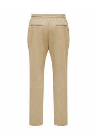 Beige Sweatpants mit glatter Textur, einem elastischen Bund und zwei Gesäßtaschen, die zum Knöchel hin zulaufen.