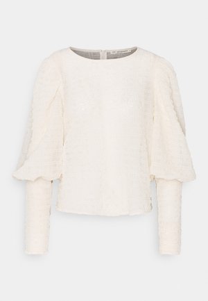 Witte, getextureerde blouse met lange mouwen, ronde halslijn en pofmouwen, met een zichtbare ritssluiting aan de achterkant.
