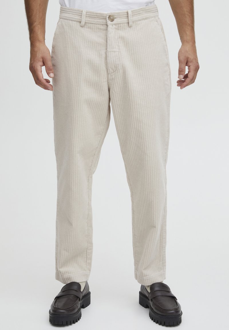 Beige corduroy trousers with vertical stripes, featuring a button closure, front pockets, and a straight cut design.