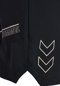 Black sports shorts with white HUMMEL logo on left side and two white chevron arrows on right side near hem.