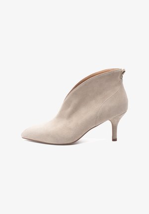 Beige suede ankle boot with a pointed toe and a slender heel. Features a side zipper and a smooth, textured surface.
