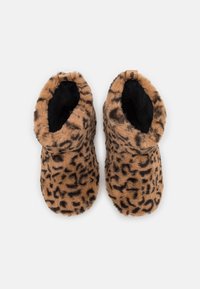Leopard print fluffy slippers with a soft textile exterior, round toe design, and black inner lining; light brown color with dark spots.