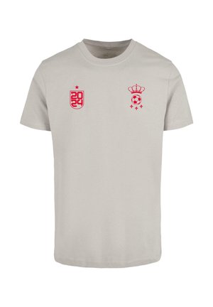 Light gray cotton t-shirt featuring pink graphic designs, including "2024" on the left and a crown and soccer ball on the right.
