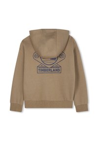Felpa color khaki con cappuccio regolabile, polsi e orlo a coste. Sul retro presenta il logo blu di Timberland con "Est. 73" e dettagli di design.