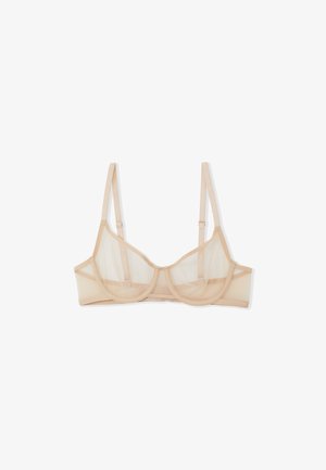 Soutien-gorge en mesh beigne avec armatures, bretelles réglables, panneaux transparents et bande sous poitrine solide ; il présente une texture lisse et un design de bonnet arrondi.