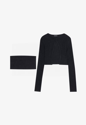 Black ribbed cropped top with long sleeves and a keyhole detail at the front, paired with a matching ribbed bandeau.