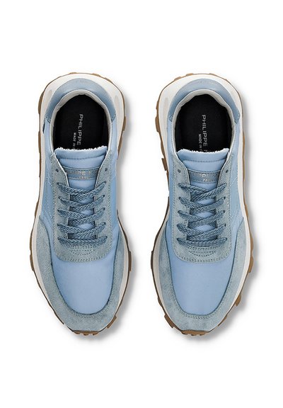 Light blue sneakers with suede and mesh upper, round toe, lace-up front, padded collar, rubber outsole, and contrasting tan accents.