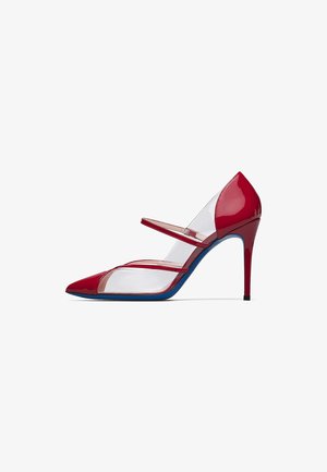 Red patent leather high-heeled shoe with pointed toe, clear PVC sides, two red straps, and a blue sole.