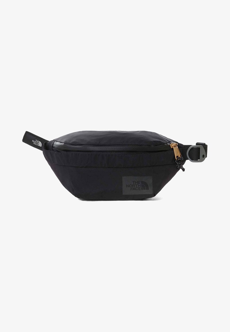 Sac banane noir The North Face avec fermeture éclair, sangle ajustable et patch logo sur fond blanc uni.