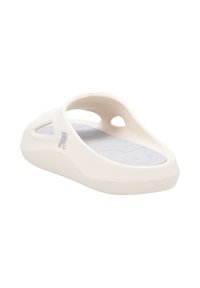 Lightweight, cream-colored slide sandal with an open design, textured gray insole, and ventilation holes for breathability.