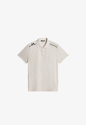 Vaaleanharmaa poolopaita, joka on valmistettu sileästä kankaasta. Varustettu mustilla yksityiskohdilla olkapäissä ja sivuilla, kolmella napilla varustettu placket, lyhyet hihat.