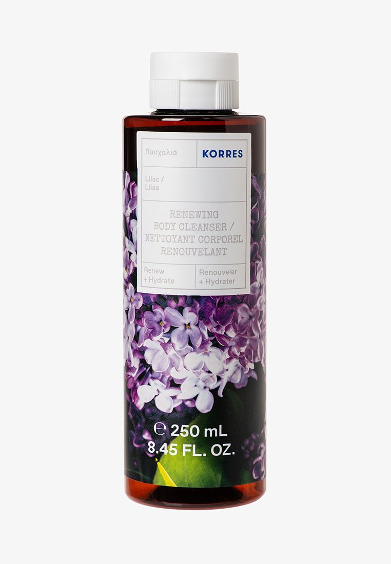 Ruskea muovipullo vartalon puhdistusaineelle, jossa on valkoinen korkki. Tä etiketti esittää liljakukkia ja siinä lukee "Korres Uudistava vartalon puhdistusaine" harmaalla tekstillä. 250 mL.
