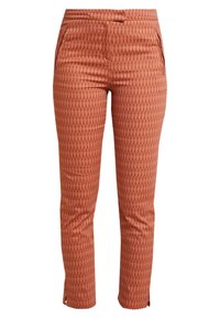 Patterned trousers in rust color, featuring a diamond texture, two side pockets, and ankle zips for adjustable fit.