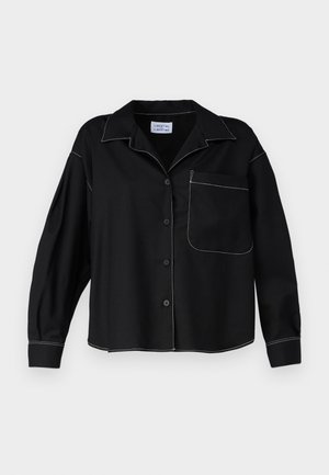 Black button-up shirt with a collar, long sleeves, and a patch pocket. White contrasting stitching along seams. Smooth fabric texture.