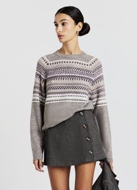 Gray knitted sweater with patterned yoke in shades of cream and burgundy, paired with a short gray skirt featuring button accents.