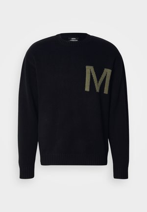 Mustard mustri kindad, mille ääred ja krae on ribatud. Vasakul küljel on ülekaaluline roheline "M". Ümar kaelus, pehme tekstuur.