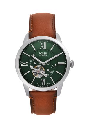 Montre-bracelet automatique Fossil avec cadran vert, mécanisme open-heart, chiffres romains argentés, et bracelet en cuir marron affichant l'heure 10h10.