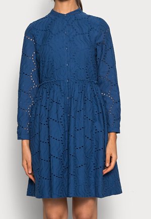 Robe en coton bleu à manches longues, boutonnée sur le devant, avec un motif de vagues brodé, comprenant des détails découpés le long des manches et du corsage.