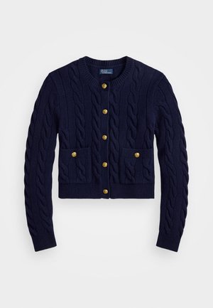 Marineblauer gestrickter Cardigan mit Kabelmuster, ausgestattet mit goldenen Knöpfen und zwei vorderen Taschen. Kurz geschnitten, mit gerippten Bündchen und Saum.