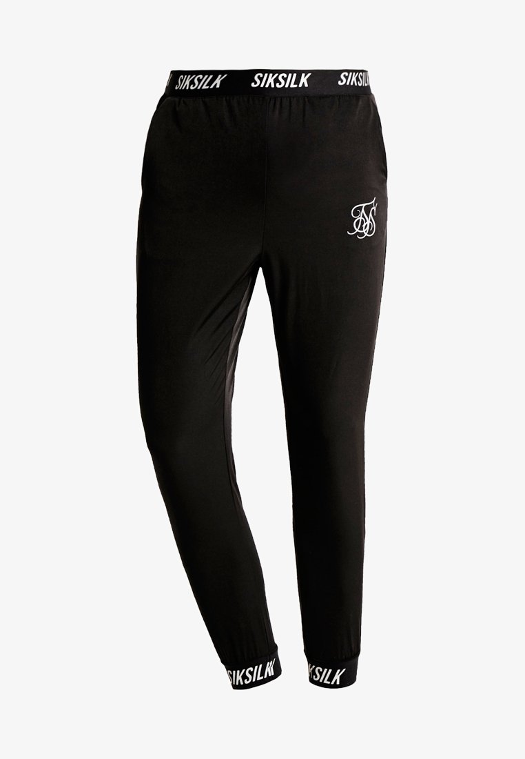 Schwarze Jogginghosen aus weichem Stoff. Mit einem elastischen Bund, der die SIKSILK-Marke trägt, und einem kleinen weißen Logo auf dem Oberschenkel. Eng anliegender Schnitt.