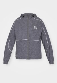 Gray windbreaker jacket with a textured finish, zip closure, hood, and white accent piping; features a small logo on the chest.