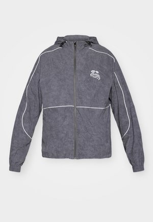 Gray windbreaker jacket with a textured finish, zip closure, hood, and white accent piping; features a small logo on the chest.
