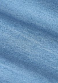 Light blue fabric with a soft texture and subtle sheen. The material appears smooth with a finely woven pattern, showing slight variations in color.
