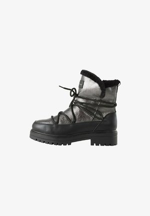 Black and metallic gray ankle boots with faux fur lining, front lacing, textured leather, and a chunky treaded sole.